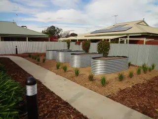 Landscaped front yard with water tanks