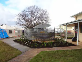 Paved path and mulched garden beside a verandah