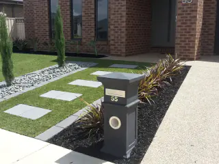 Letterbox, paths and lawn at a finished home