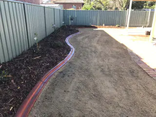 Irrigation line laid across a yard before turf