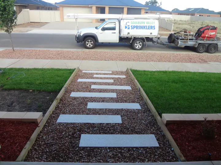 Goulburn Valley Sprinklers ute and trailer parked at a finished front yard